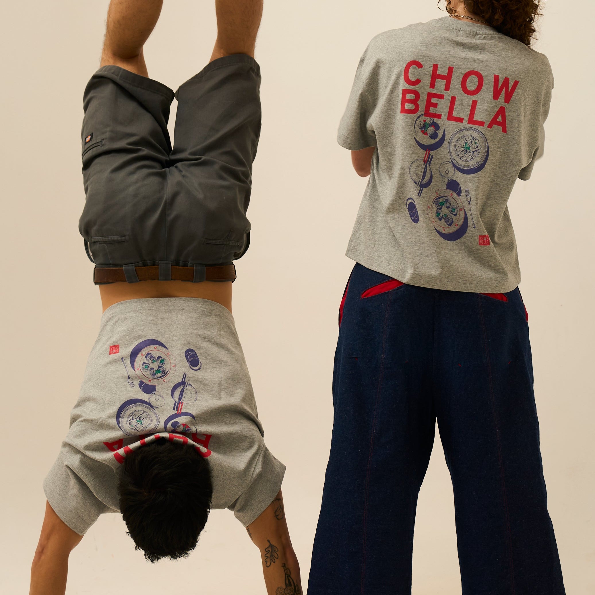Two people wearing gray t-shirts with 'CHOW BELLA' text, one upside down.